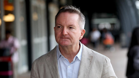 Australian Minister for Climate Change and Energy Chris Bowen wearing a light jacket, pictured outside. Sad about Australian Power Prices